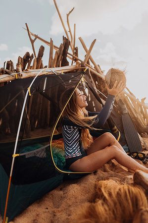 survival tent - Woman by tent happy with her collection of coconuts, Princeville, Hawaii, US Stock Photo - Premium Royalty-Free, Code: 614-09270242