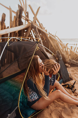 survival tent - Woman by tent happy with her collection of coconuts, Princeville, Hawaii, US Stock Photo - Premium Royalty-Free, Code: 614-09270243