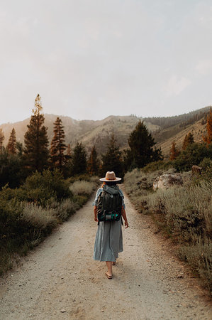 simsearch:614-09110951,k - Young woman in maxi dress wearing backpack walking along rural road, rear view, Mineral King, California, USA Photographie de stock - Premium Libres de Droits, Code: 614-09270481