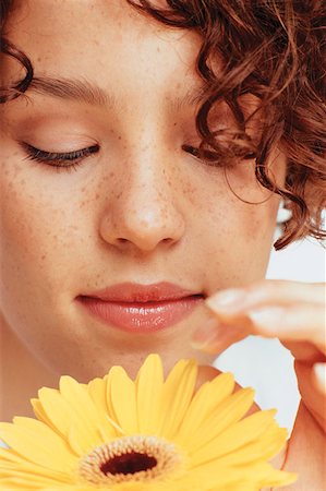 Young woman with flower Stock Photo - Premium Royalty-Free, Code: 614-00386263