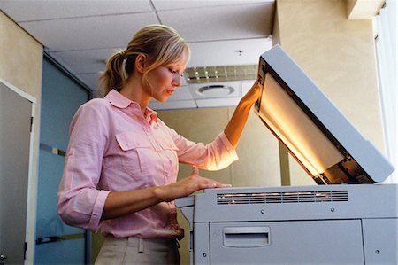 person photocopy - Woman using a photocopier Stock Photo - Premium Royalty-Free, Code: 614-00389055