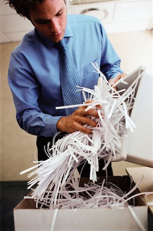 Man emptying shredder bin Fotografie stock - Premium Royalty-Free, Codice: 614-00389051