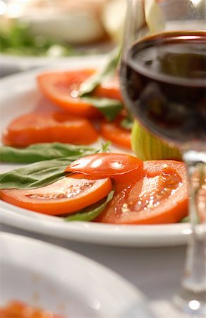 Wine glass by plate of tomatoes Stock Photo - Premium Royalty-Free, Code: 614-00380865