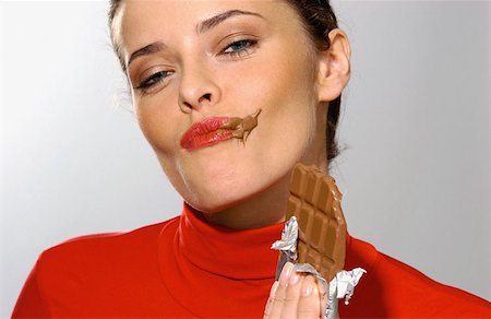 Young woman eating chocolate Stock Photo - Premium Royalty-Free, Code: 614-00382417