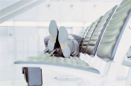 Businessman relaxing in airport lounge Stock Photo - Premium Royalty-Free, Code: 614-00395640