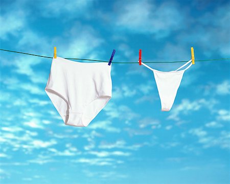 Woman behind a huge pair of underwear on a clothesline Stock Photo