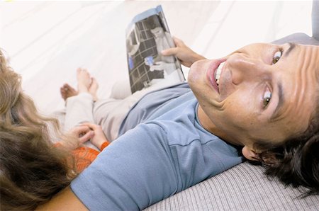 people laughing magazine - Couple on sofa Stock Photo - Premium Royalty-Free, Code: 614-00391957