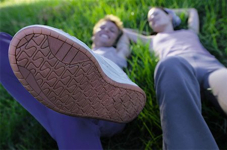 Couple lying in grass Stock Photo - Premium Royalty-Free, Code: 614-00392022