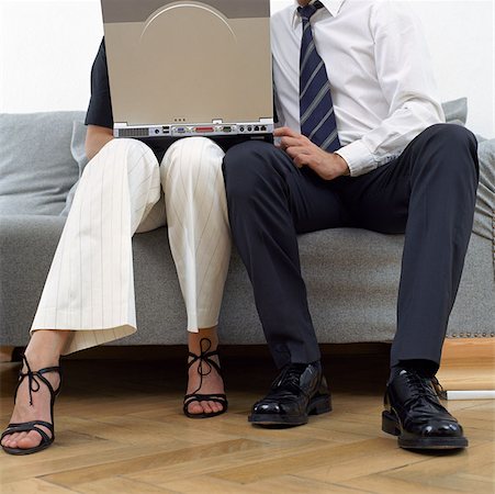 Couple sitting with laptop Stock Photo - Premium Royalty-Free, Code: 614-00594511