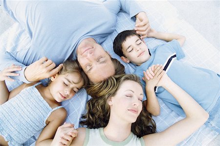 Family lying down sleeping Stock Photo - Premium Royalty-Free, Code: 614-00597596