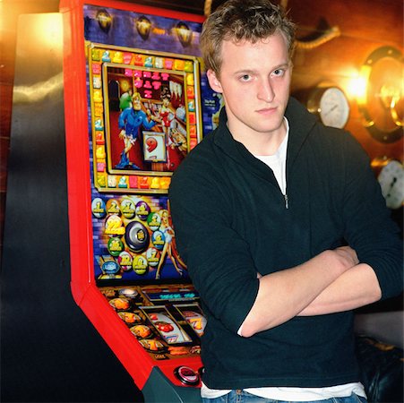 slot casino interior - Boy standing by slot machine Stock Photo - Premium Royalty-Free, Code: 614-00597835