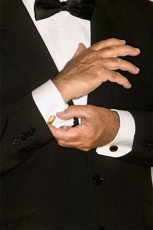 Senior man adjusting cuff links Stock Photo - Premium Royalty-Free, Code: 614-00599111