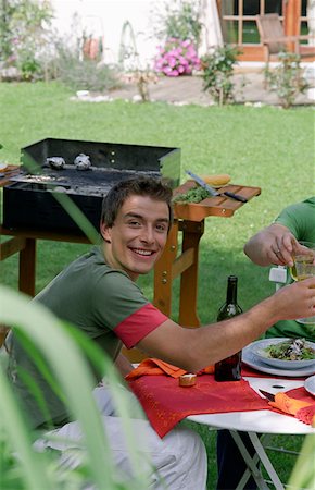 simsearch:652-03633426,k - Young man enjoying meal. Stock Photo - Premium Royalty-Free, Code: 614-00599432