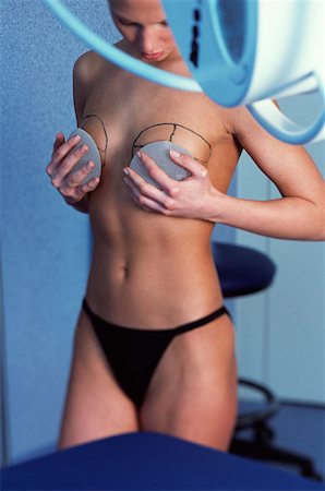 Woman preparing for breast implant operation Stock Photo - Premium Royalty-Free, Code: 614-00599680