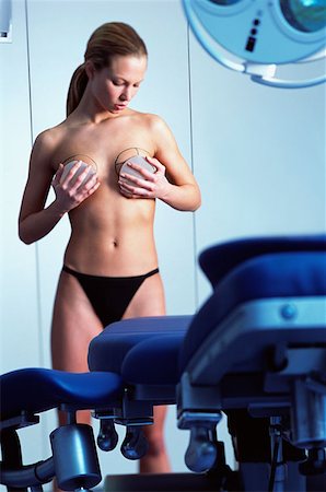 Woman preparing for breast implant operation Stock Photo - Premium Royalty-Free, Code: 614-00599681