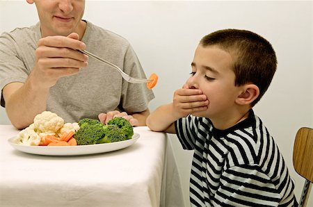 Boy rejecting vegetables Stock Photo - Premium Royalty-Free, Code: 614-00599849