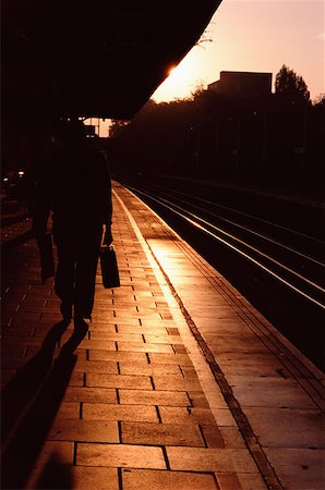 silhouette railway station - Silhouetted commuter on railroad platform Stock Photo - Premium Royalty-Free, Code: 614-00601701
