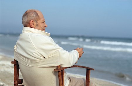 deckchair senior man - Senior man looking at waves Stock Photo - Premium Royalty-Free, Code: 614-00602606