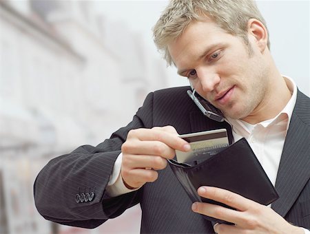 Man on mobile with credit card Stock Photo - Premium Royalty-Free, Code: 614-00654383