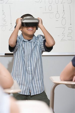 Boy wearing virtual reality headset Stock Photo - Premium Royalty-Free, Code: 614-00654666