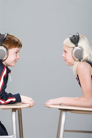 Boy and girl wearing headphones Stock Photo - Premium Royalty-Free, Code: 614-00654679