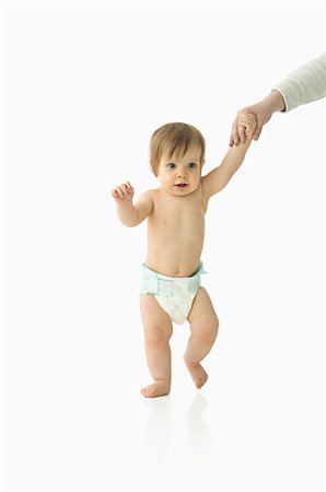 Adult helping baby to walk Stock Photo - Premium Royalty-Free, Code: 614-00654832