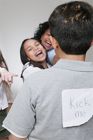 Girls bullying a boy Stock Photo - Premium Royalty-Free, Code: 614-00655151