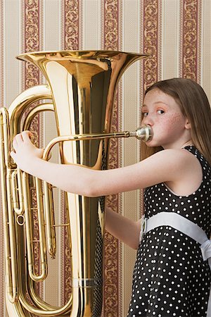 Girl playing tuba Stock Photo - Premium Royalty-Free, Code: 614-00655359