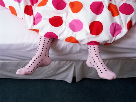 Feet dangling out of bed Stock Photo - Premium Royalty-Free, Code: 614-00655496