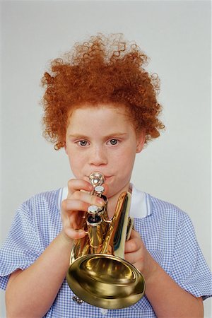 redheaded trumpet players - Girl playing the trumpet Stock Photo - Premium Royalty-Free, Code: 614-00658816