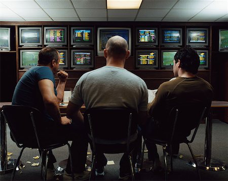 fist on table - Three men in a betting shop Stock Photo - Premium Royalty-Free, Code: 614-00659281