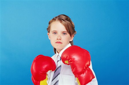 Girl wearing boxing gloves Stock Photo - Premium Royalty-Free, Code: 614-00659305