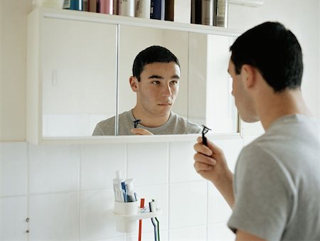 Teenage boy preparing to shave Stock Photo - Premium Royalty-Free, Code: 614-00653379