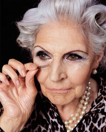 false eyelashes on older women - Senior woman applying fake eyelashes Stock Photo - Premium Royalty-Free, Code: 614-00653577