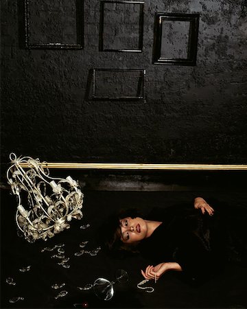 drucken - Woman lying on floor with broken chandelier Stock Photo - Premium Royalty-Free, Code: 614-00653616