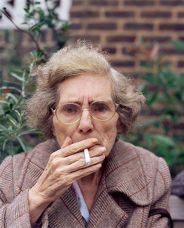 Elderly woman smoking Stock Photo - Premium Royalty-Free, Code: 614-00653647