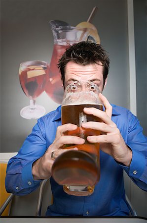 Man drinking beer from glass boot Stock Photo - Premium Royalty-Free, Code: 614-00653784