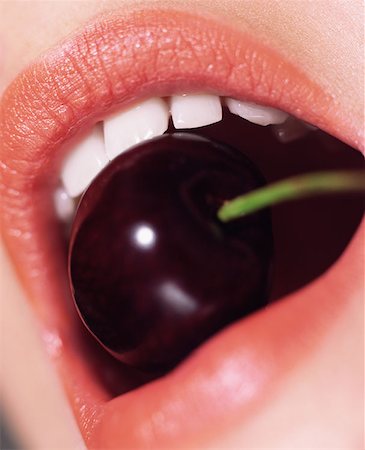 eat mouth closeup - Woman biting a cherry Stock Photo - Premium Royalty-Free, Code: 614-00683962