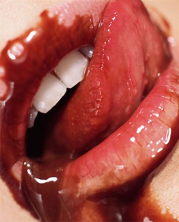 person licking lips - Chocolate sauce spilling out of woman's mouth Stock Photo - Premium Royalty-Free, Code: 614-00683974