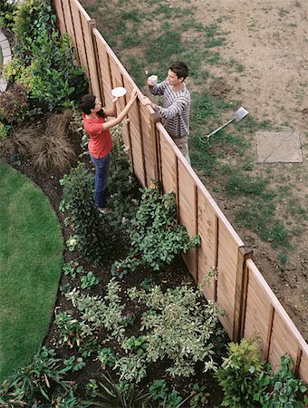 Neighbours having coffee over the fence Stock Photo - Premium Royalty-Free, Code: 614-00694377