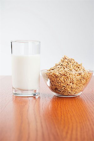 A glass of milk and a bowl of muesli Stock Photo - Premium Royalty-Free, Code: 614-00695021
