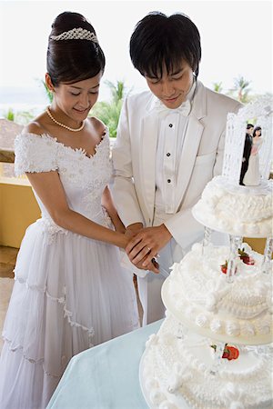 someone cutting cake - Bride and groom cutting wedding cake Stock Photo - Premium Royalty-Free, Code: 614-00778275