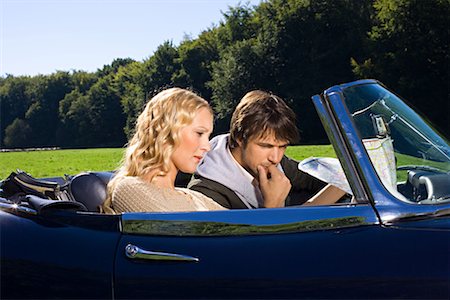 Couple looking at map in car Stock Photo - Premium Royalty-Free, Code: 614-00808249