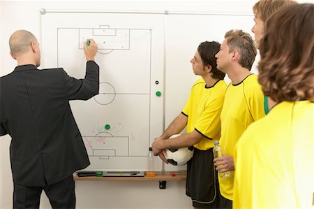 Coach drawing on whiteboard Stock Photo - Premium Royalty-Free, Code: 614-00808596