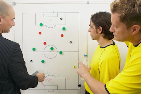 Coach and soccer players discuss strategy Stock Photo - Premium Royalty-Free, Code: 614-00808591