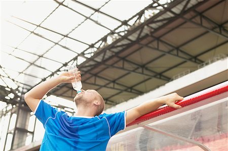 exhausted football player - Footballer drinking Stock Photo - Premium Royalty-Free, Code: 614-00808648