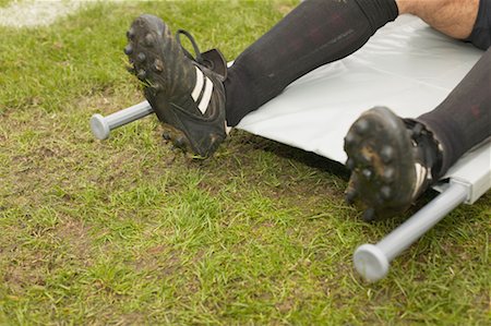 Footballer on a stretcher Stock Photo - Premium Royalty-Free, Code: 614-00808655