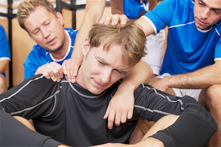 football locker room photography - Footballers consoling team mate Stock Photo - Premium Royalty-Free, Code: 614-00808672