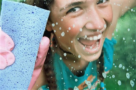 sponge with suds - Girl cleaning glass with sponge Stock Photo - Premium Royalty-Free, Code: 614-00808694