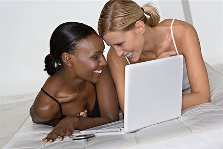 Girlfriends with laptop computer Stock Photo - Premium Royalty-Free, Code: 614-00844204